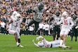 (David Zalubowski | AP) Colorado wide receiver Travis Hunter, top center, flies in for a touchdown past, from left, Utah linebacker Johnathan Hall, cornerback Smith Snowden and safety Nate Ritchie in the second half of an NCAA college football game Saturday, Nov. 16, 2024, in Boulder, Colo.