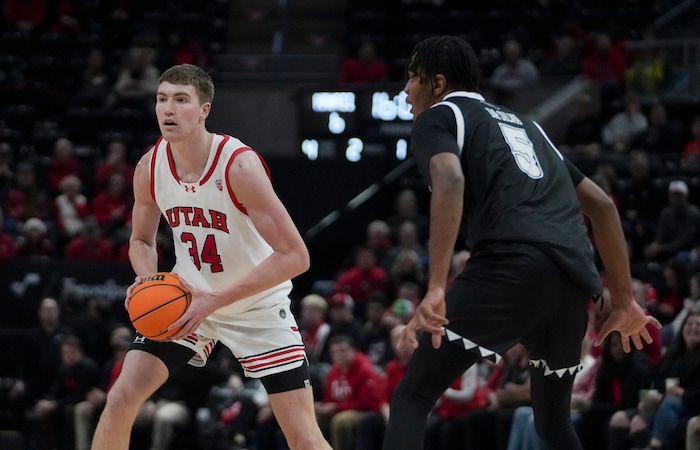 (Bethany Baker  |  The Salt Lake Tribune) Utah Utes center Lawson Lovering (34) looks to pass the ball as Hawaii Warriors forward Bernardo da Silva (5) defends at the Delta Center in Salt Lake City on Thursday, Nov. 30, 2023.
