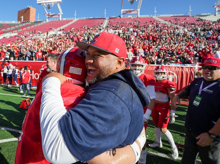 (Chris Samuels | The Salt Lake Tribune) Crimson Cliffs head coach Wayne Alofipo celebrates with players after winning the 4A high school football championship game against Green Canyon at Rice-Eccles Stadium, Friday, Nov. 17, 2023.