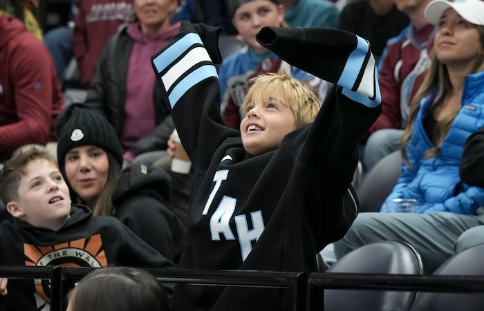 (Bethany Baker  |  The Salt Lake Tribune) A fan cheers during the game between the Utah Hockey Club and the Colorado Avalanche at the Delta Center in Salt Lake City on Thursday, Oct. 24, 2024.