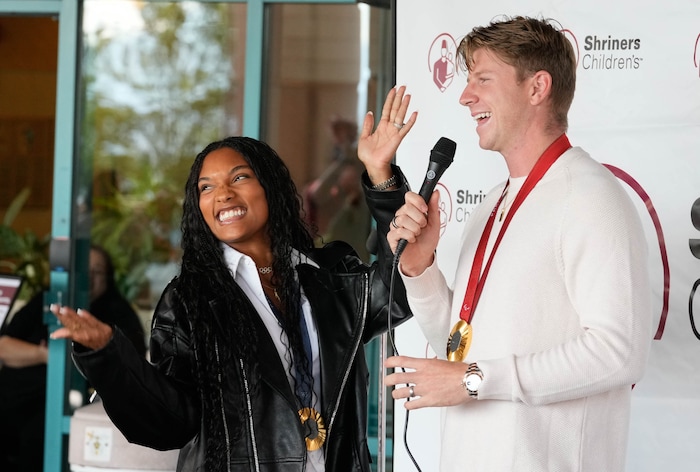 (Francisco Kjolseth  | The Salt Lake Tribune) Hunter Woodhall and Tara Davis-Woodhall, both gold medalists in the Paris 2024 Games, recount their Olympic wins as they visit with kids at Shriners Children’s Hospital on Wednesday, Sept. 18, 2024. Woodhall had his legs amputated when he was 11 months old and spent much of his youth at the hospital.