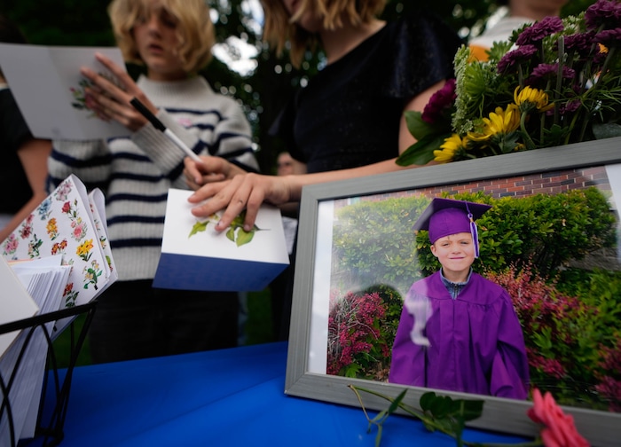 (Francisco Kjolseth  |  The Salt Lake Tribune) Photos of 6-year-old Uintah Elementary first grader Adlai Owen, are displayed at Laird Park in Salt Lake City during a memorial on Wednesday, May 22, 2024. Police say Adlai’s father, Sam Owen, fatally shot Adlai before killing himself in an apparent murder-suicide on Saturday, May 18, 2024.