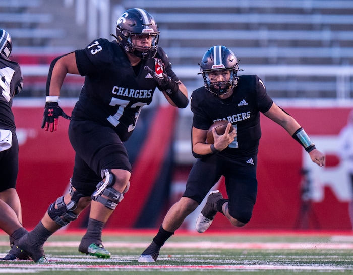 (Rick Egan | The Salt Lake Tribune) Corner Canyon QB Isaac Wilson (1), runs for a touchdown, in the Chargers 6A State championship win over the Skyridge Falcons, at Rice-Eccles Stadium, on Friday, Nov. 17, 2023.