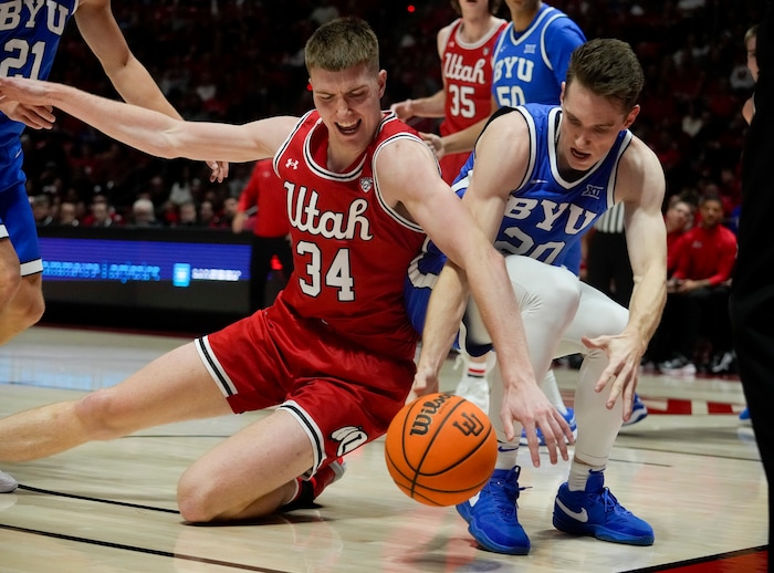 (Bethany Baker  |  The Salt Lake Tribune) Utah Utes center Lawson Lovering (34) and Brigham Young Cougars guard Spencer Johnson (20) fight for the ball at the Jon M. Huntsman Center in Salt Lake City on Saturday, Dec. 9, 2023.