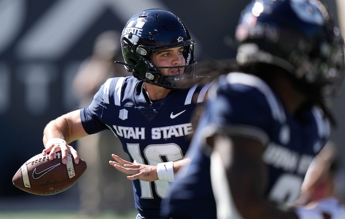 (Francisco Kjolseth  | The Salt Lake Tribune) Utah State Aggies quarterback Bryson Barnes spots his shot as Utah State hosts the University of Utah during the first half of an NCAA college football game Saturday, Sept. 14, 2024, in Logan, Utah.