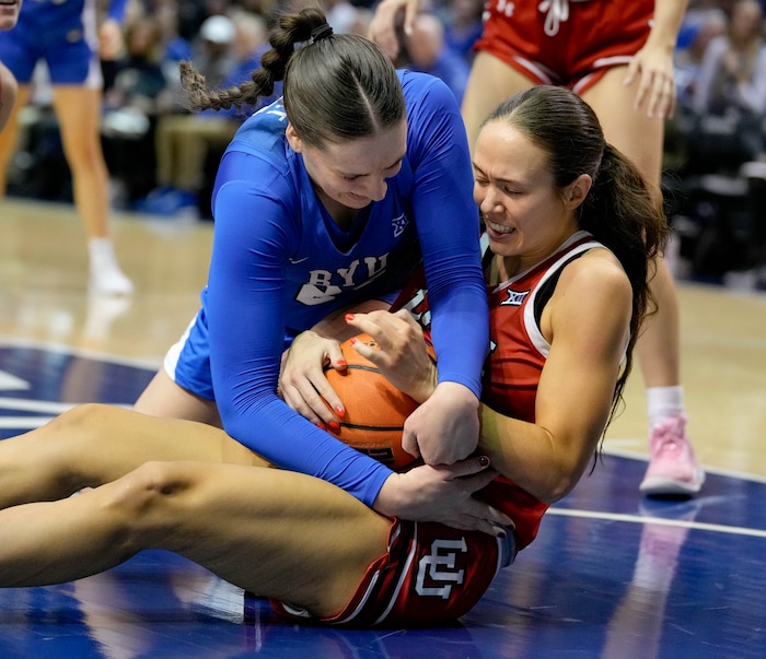 (Francisco Kjolseth  | The Salt Lake Tribune) BYU Cougars forward Emma Calvert (25) fights for the ball with Utah Utes forward Jenna Johnson (22) as BYU hosts Utah, NCAA basketball in Provo on Saturday, Jan. 25, 2025.