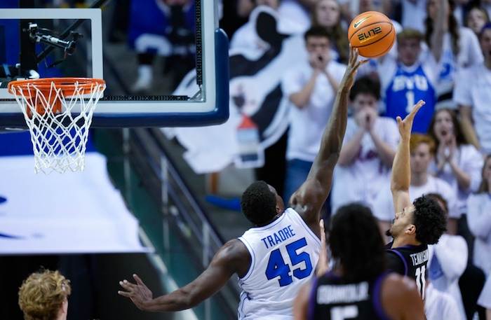 (Francisco Kjolseth  |  The Salt Lake Tribune) Brigham Young Cougars forward Fousseyni Traore (45) puts the block on TCU Horned Frogs guard Trevian Tennyson (11) during an NCAA college basketball game against TCU Saturday, March 2, 2024, in Provo, Utah.