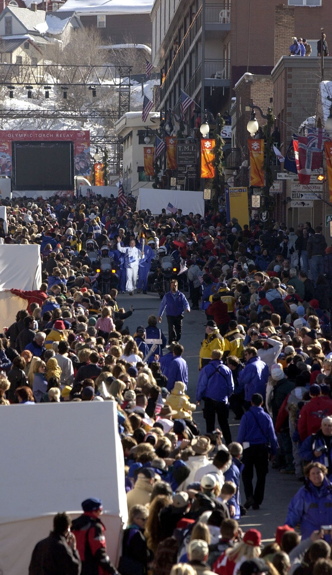 (Rick Egan | The Salt Lake Tribune) Former skier Bill Marolt runs with the Olympic torch on Main Street in Park City, Feb. 7, 2002.