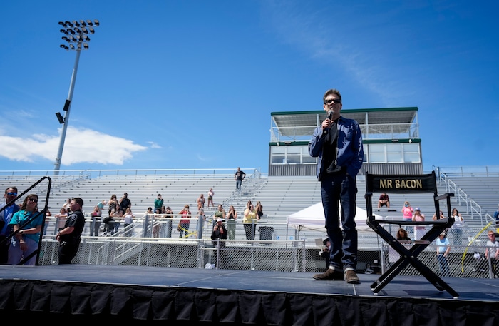 (Bethany Baker  |  The Salt Lake Tribune) Kevin Bacon speaks on stage during a charity event to commemorate the 40th anniversary of the movie "Footloose" on the football field of Payson High School in Payson on Saturday, April 20, 2024.