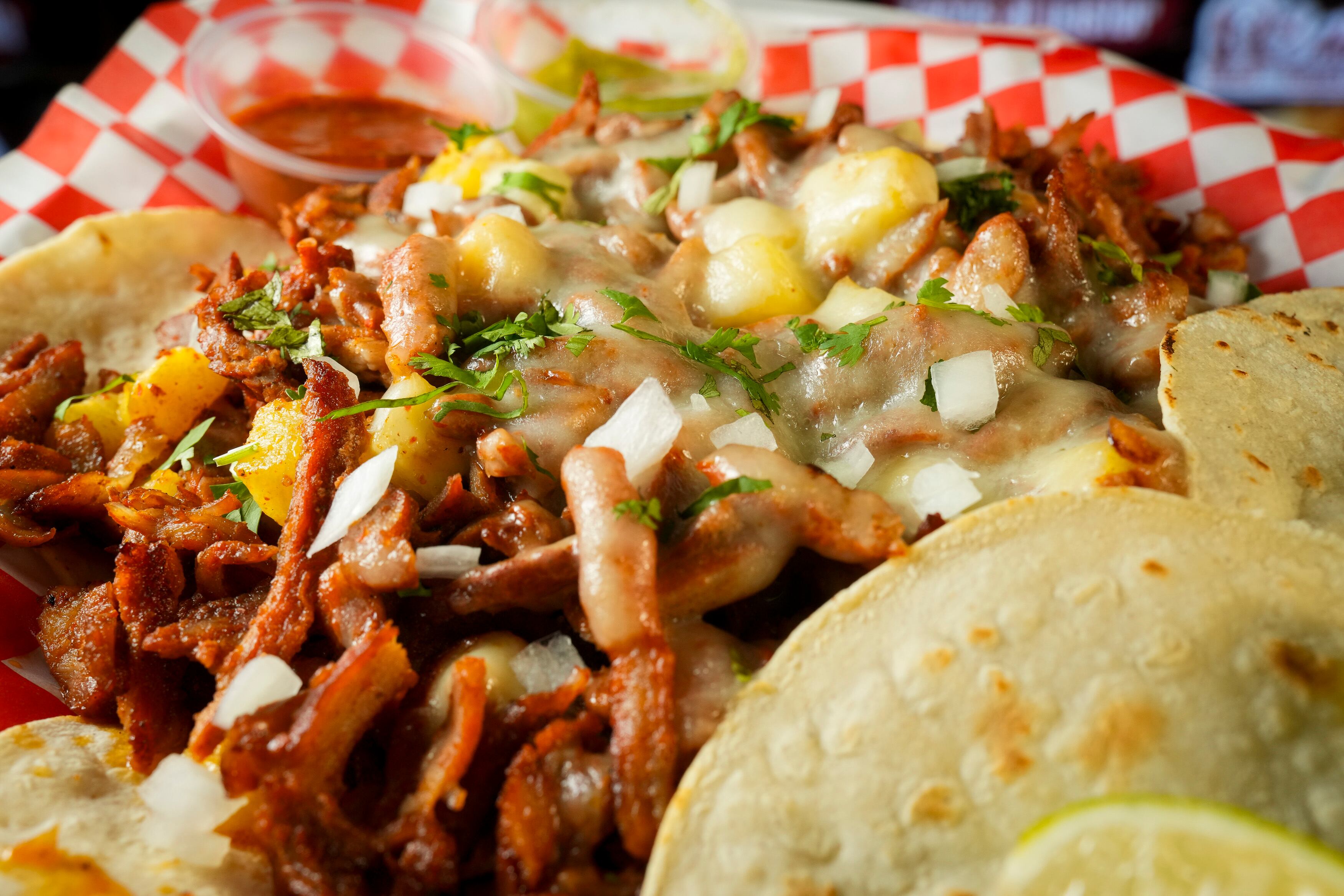 (Bethany Baker | The Salt Lake Tribune) A plate of pastor con queso y pina sits on a table at Tortas Y Jugos El Morelense, Inc. in Salt Lake City on Aug. 1, 2024.