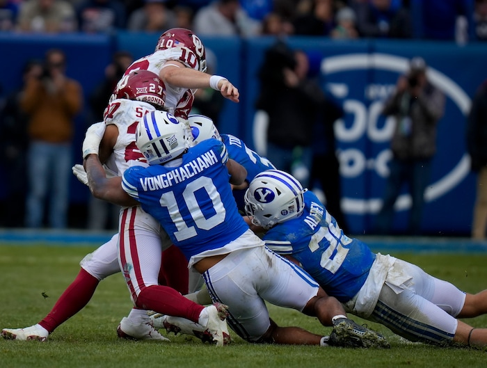 (Bethany Baker  |  The Salt Lake Tribune) Brigham Young Cougars tackle Oklahoma Sooners quarterback Jackson Arnold (10) at LaVell Edwards Stadium in Provo on Saturday, Nov. 18, 2023.