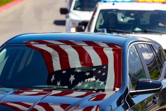 (Francisco Kjolseth  |  The Salt Lake Tribune) The funeral procession follows the hearse containing the body of Santaquin police Sgt. Bill Hooser following ceremonies at the UCCU Center at Utah Valley University in Orem on Monday, May 13, 2024.