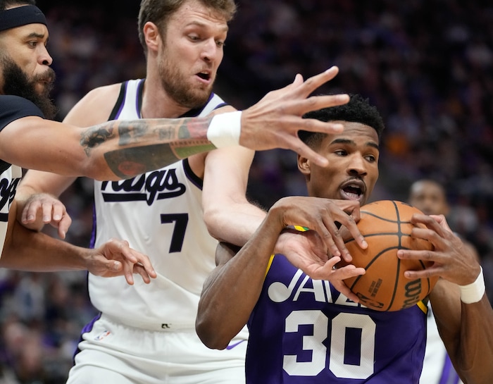 (Francisco Kjolseth  |  The Salt Lake Tribune) Utah Jazz guard Ochai Agbaji (30) tries to regain control of the ball as Sacramento Kings forward Sasha Vezenkov (7) puts on the pressure as the Utah Jazz host the Sacramento Kings, during NBA basketball in Salt Lake City on Wednesday, Oct. 25, 2023.