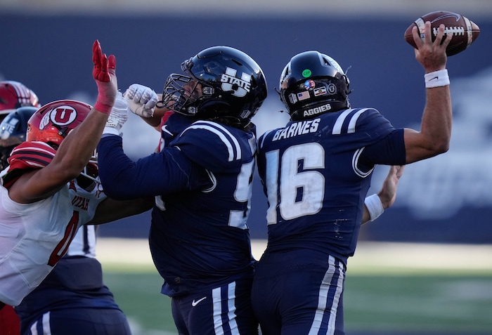 (Francisco Kjolseth  | The Salt Lake Tribune) Utah State Aggies quarterback Bryson Barnes (16) gets a pass away in time as Utah State hosts the University of Utah during the second half of an NCAA college football game Saturday, Sept. 14, 2024, in Logan, Utah.