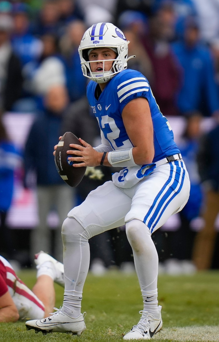 (Bethany Baker  |  The Salt Lake Tribune) Brigham Young Cougars quarterback Jake Retzlaff (12) looks to pass the ball against the Oklahoma Sooners at LaVell Edwards Stadium in Provo on Saturday, Nov. 18, 2023.