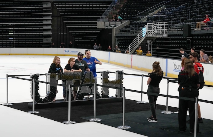 (Francisco Kjolseth  |  The Salt Lake Tribune) People pose for photographs on the ice as the Utah Hockey Club hosts their first NHL draft party at the Delta Center on Friday, June 28, 2024.