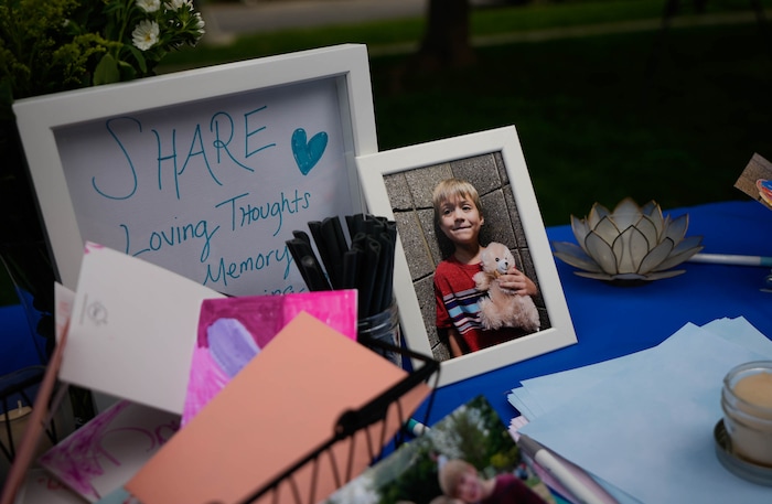 (Francisco Kjolseth  |  The Salt Lake Tribune) People write loving notes during a memorial at Laird Park in Salt Lake City on Wednesday, May 22, 2024, to honor Adlai Owen. Police say Adlai’s father, Sam Owen, fatally shot Adlai before killing himself in an apparent murder-suicide on Saturday, May 18, 2024.