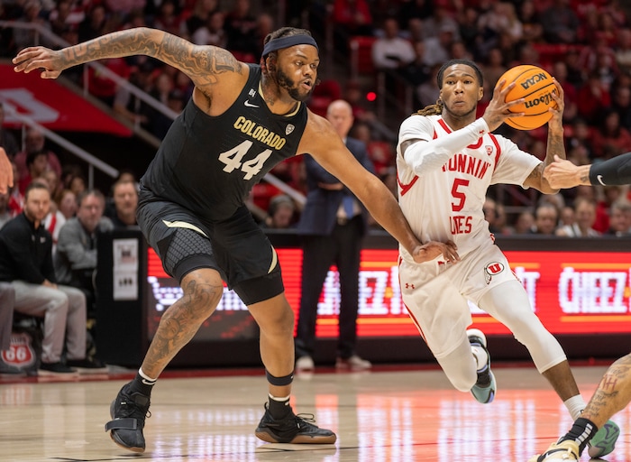 (Rick Egan | The Salt Lake Tribune) Utah Utes guard Deivon Smith (5) takes the ball inside, as Colorado Buffaloes center Eddie Lampkin Jr. (44) defends, in PAC-12 basketball action between the Utah Utes and the Colorado Buffaloes a the Jon M. Huntsman Center, on Saturday, Feb. 3, 2024.
