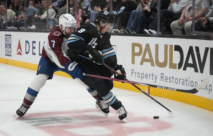 (Bethany Baker  |  The Salt Lake Tribune) Utah Hockey Club center Clayton Keller (9) vies for the puck with Colorado Avalanche defenseman Devon Toews (7) during the game between the Utah Hockey Club and the Colorado Avalanche at the Delta Center in Salt Lake City on Thursday, Oct. 24, 2024.