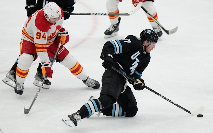 (Francisco Kjolseth  | The Salt Lake Tribune) Utah Hockey Club center Barrett Hayton (27) loses his footing agains the Calgary Flames during an NHL hockey game at the Delta Center in Salt Lake City on Wednesday, Oct. 30, 2024.