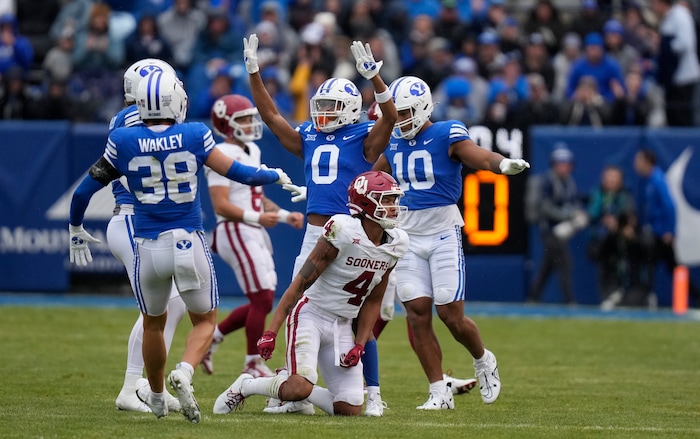 (Bethany Baker  |  The Salt Lake Tribune) Brigham Young Cougars celebrate after a play against the Oklahoma Sooners at LaVell Edwards Stadium in Provo on Saturday, Nov. 18, 2023.