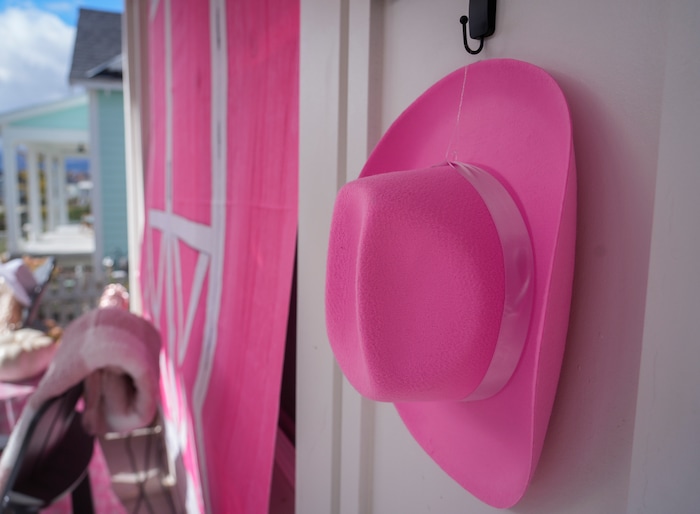 (Bethany Baker  |  The Salt Lake Tribune) A pink cowboy hat hangs on a house decorated as “Barbie Barn” in a section of Daybreak that has collectively created a Barbieland-themed community for Halloween on Wednesday, Oct. 11, 2023.