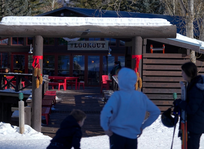 (Bethany Baker  |  The Salt Lake Tribune) People stand in front of a restaurant at Sundance Resort near Provo on Thursday, Dec. 14, 2023.