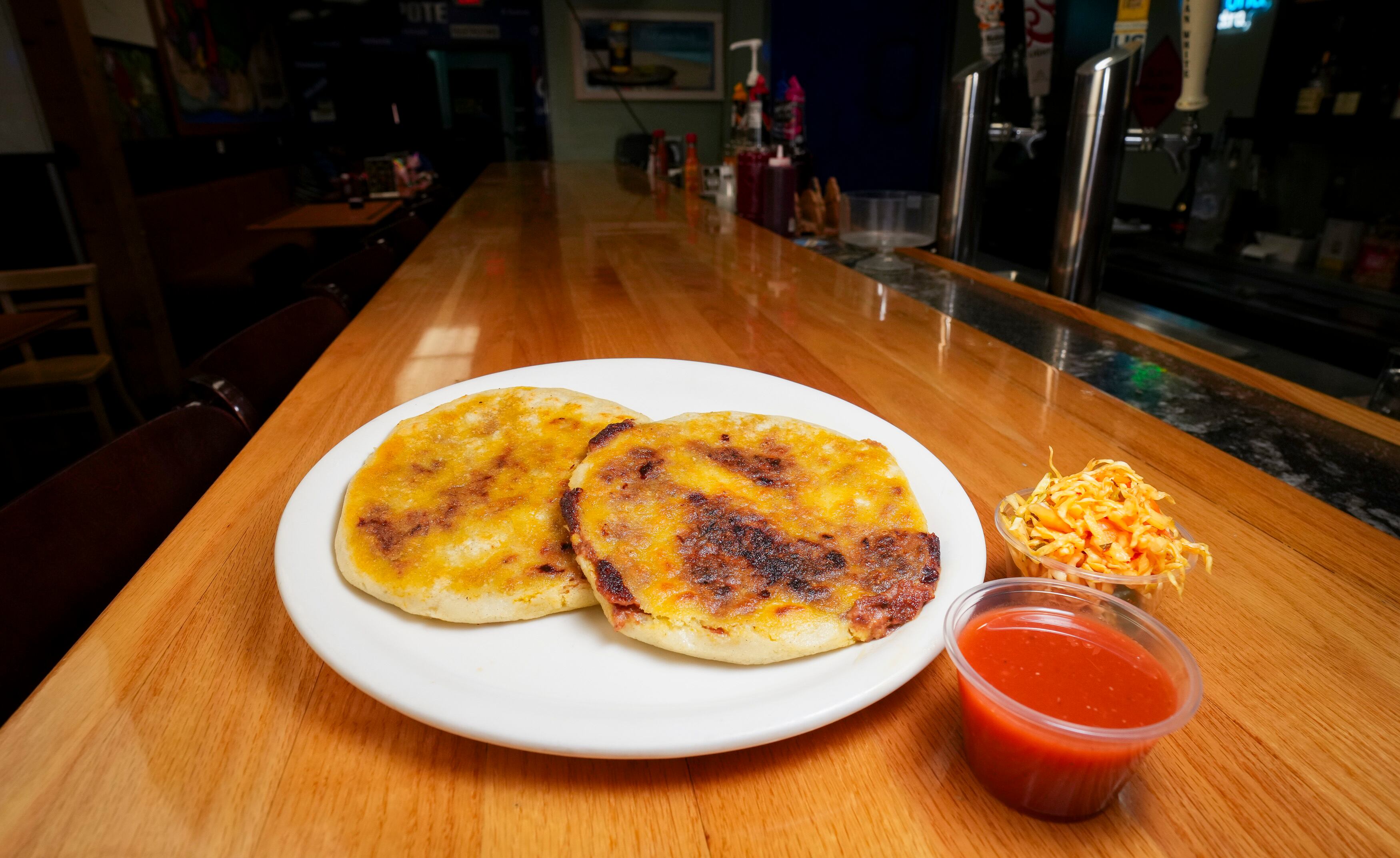 (Bethany Baker | The Salt Lake Tribune) Two pupusas sit on a plate at Catrachos in West Valley City on Aug. 2, 2024.