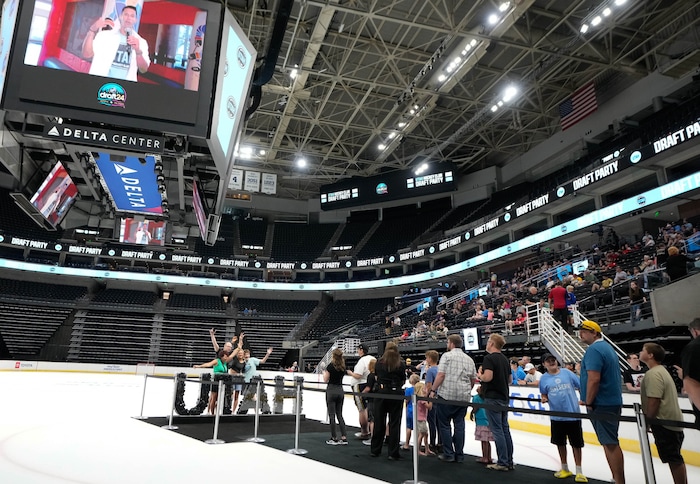 (Francisco Kjolseth  |  The Salt Lake Tribune) Fans have their picture taken on the ice as the Utah Hockey Club hosts their first NHL draft party at the Delta Center on Friday, June 28, 2024.