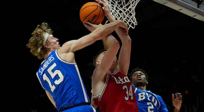 (Bethany Baker  |  The Salt Lake Tribune) Brigham Young Cougars guard Richie Saunders (15) fouls Utah Utes center Lawson Lovering (34) at the Jon M. Huntsman Center in Salt Lake City on Saturday, Dec. 9, 2023.