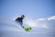 (Tristan Sadler | Powder Mountain) A snowboarder carves through fresh powder in terrain off the Timberline lift during opening weekend at Powder Mountain on Dec. 9, 2023. The resort plans to limit access on February weekends to passholders.