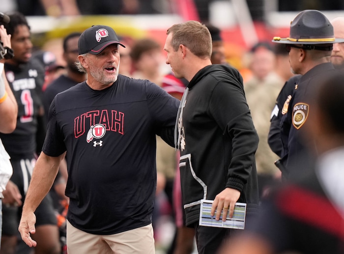 (Francisco Kjolseth  |  The Salt Lake Tribune) Coach Kyle Whittingham meets with Arizona State Sun Devils coach Kenny Dillingham following Utah’s 55-3 win in Salt Lake City on Saturday, Nov. 4, 2023.