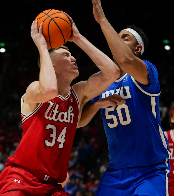 (Bethany Baker  |  The Salt Lake Tribune) Utah Utes center Lawson Lovering (34) shoots as Brigham Young Cougars center Aly Khalifa (50) defends at the Jon M. Huntsman Center in Salt Lake City on Saturday, Dec. 9, 2023.