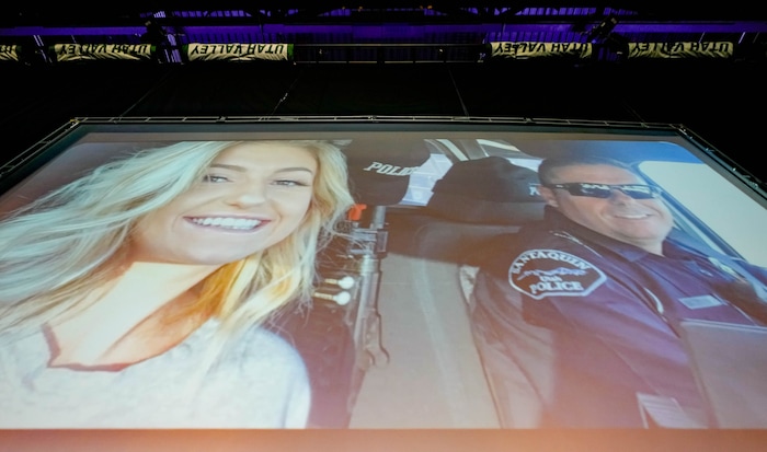 (Francisco Kjolseth  |  The Salt Lake Tribune) Family photos are projected during funeral services for Santaquin police Sgt. Bill Hooser at the UCCU Center at Utah Valley University on Monday, May 13, 2024.