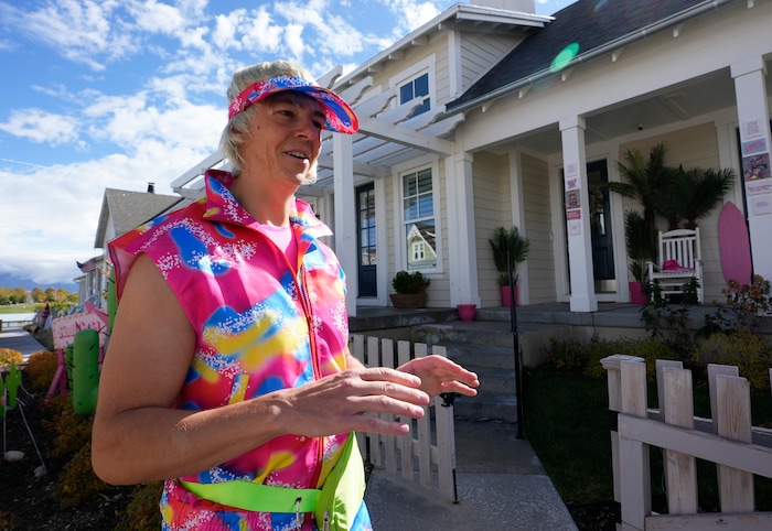 (Bethany Baker  |  The Salt Lake Tribune) Dave Mantyla, dressed as “Real World Ken” from the movie “Barbie,” answers questions outside his decorated home in a section of Daybreak that has collectively created a Barbieland-themed community for Halloween on Wednesday, Oct. 11, 2023.