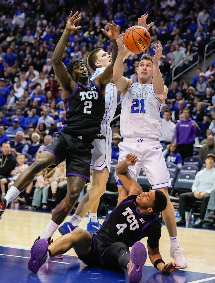 (Francisco Kjolseth  |  The Salt Lake Tribune) TCU Horned Frogs guard Jameer Nelson Jr. (4) end up on the floor as TCU Horned Frogs forward Emanuel Miller (2) battles Brigham Young Cougars forward Noah Waterman (0) and Brigham Young Cougars guard Trevin Knell (21) during an NCAA college basketball game against TCU Saturday, March 2, 2024, in Provo, Utah.