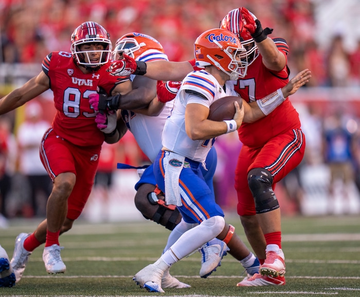 (Rick Egan | The Salt Lake Tribune) Utah Utes defensive end Jonah Elliss (83) and defensive tackle Keanu Tanuvasa (57) move in to sack Florida Gators quarterback Graham Mertz (15) in football action between the Utah Utes and the Florida Gators at Rice-Eccles Stadium on Thursday, Aug. 31, 2023.