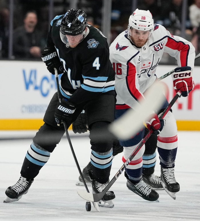 (Francisco Kjolseth  | The Salt Lake Tribune) Utah Hockey Club defenseman Juuso Valimaki (4) is pressured by Washington Capitals right wing Taylor Raddysh (16) during an NHL hockey game at the Delta Center in Salt Lake City on Monday, Nov. 18, 2024.