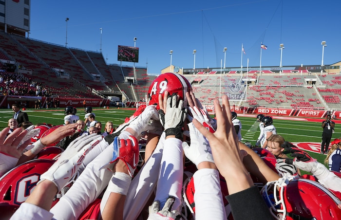 (Chris Samuels | The Salt Lake Tribune) Crimson Cliffs players hold the helmet of Scott Nisson, who was injured during the game, after winning the 4A high school football championship against Green Canyon at Rice-Eccles Stadium, Friday, Nov. 17, 2023.