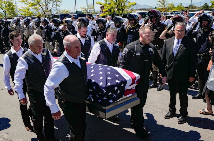 (Francisco Kjolseth  |  The Salt Lake Tribune) Pallbearers carry the casket containing Santaquin police Sgt. Bill Hooser following services at the UCCU Center at Utah Valley University on Monday, May 13, 2024.