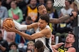 San Antonio Spurs center Victor Wembanyama (1) grabs a rebound from Utah Jazz forward John Collins (20) during the second half of an NBA basketball game, Thursday, Oct. 31, 2024, in Salt Lake City. (AP Photo/Rick Egan)