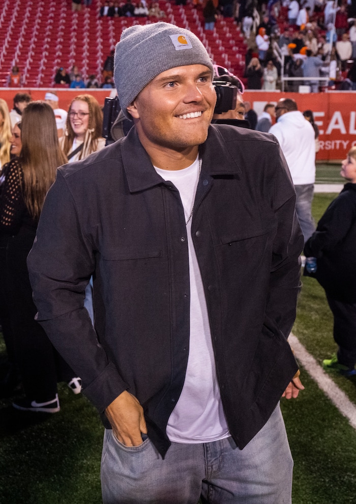 (Rick Egan | The Salt Lake Tribune) Zach Wilson on the field to congratulate his brother, Corner Canyon QB Isaac Wilson (1), as they celebrate the Chargers 6A State championship win over the Skyridge Falcons, at Rice-Eccles Stadium, on Friday, Nov. 17, 2023.