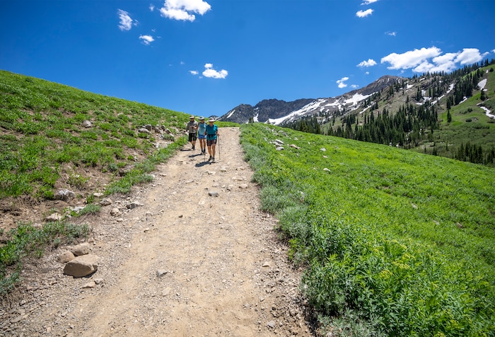 (Rick Egan | The Salt Lake Tribune) Hikers make their way down the trail from Cecret Lake, in Little Cottonwood Canyon, on Wednesday, July 12, 2023.
