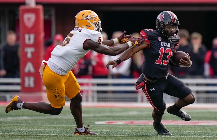 (Francisco Kjolseth  |  The Salt Lake Tribune) Utah Utes quarterback Nate Johnson (13) eludes Arizona State Sun Devils defensive back Chris Edmonds (5) for a 59-yard touchdown run in Salt Lake City on Saturday, Nov. 4, 2023.