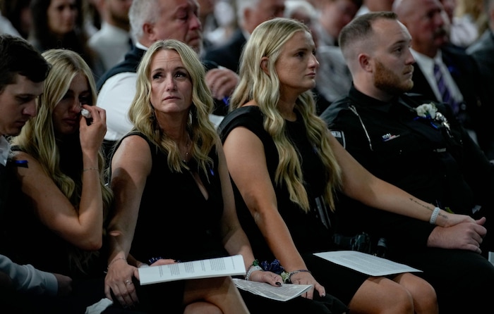 (Francisco Kjolseth  |  The Salt Lake Tribune) Kinda Hooser looks up at those in attendance during funeral services for her husband, Santaquin police Sgt. Bill Hooser at the UCCU Center at Utah Valley University on Monday, May 13, 2024.