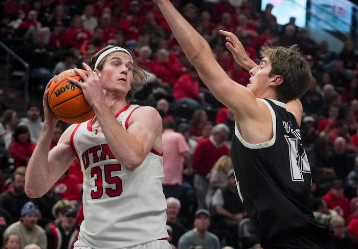 (Bethany Baker  |  The Salt Lake Tribune) Utah Utes center Branden Carlson (35) looks to pass as Hawaii Warriors forward Harry Rouhliadeff (14) blocks at the Delta Center in Salt Lake City on Thursday, Nov. 30, 2023.