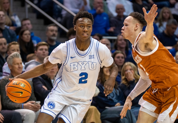 (Rick Egan | The Salt Lake Tribune) Brigham Young Cougars guard Jaxson Robinson (2) is guarded by  Texas Longhorns guard Chendall Weaver (2), in basketball action between the Brigham Young Cougars and the Texas Longhorns, at the Marriott Center, on Saturday, Jan. 27, 2024.
