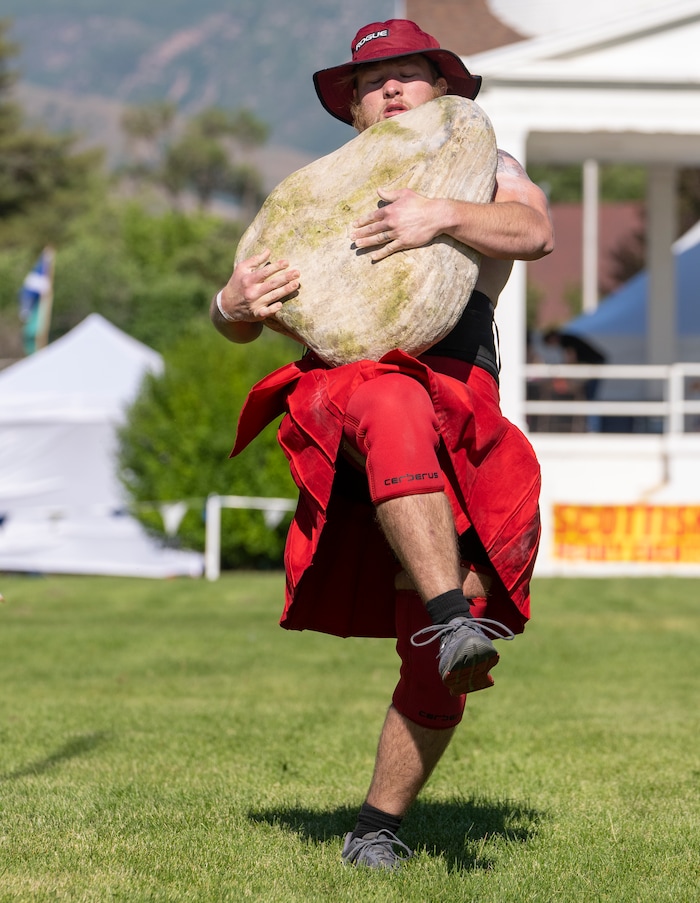 (Rick Egan | The Salt Lake Tribune)  Alex Peterson competes in the Stone Carry event during the Utah Stones of Strength Strongman competition at the Utah Scottish Festival, at the Utah State Fairpark, on Friday, June 16, 2023.
