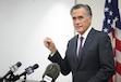 (Bethany Baker  |  The Salt Lake Tribune) Sen. Mitt Romney holds up a campaign pin during his farewell press conference at Wallace F. Bennett Federal Building in Salt Lake City on Friday, Dec. 13, 2024.