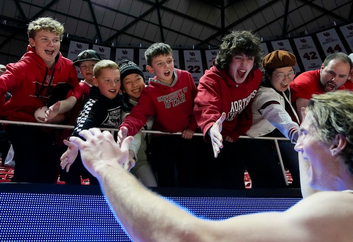 (Bethany Baker  |  The Salt Lake Tribune) Utah Utes fans high fives Utah Utes center Branden Carlson (35) after defeating the Brigham Young Cougars at the Jon M. Huntsman Center in Salt Lake City on Saturday, Dec. 9, 2023.